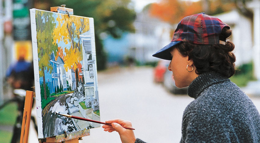 A woman painting outside