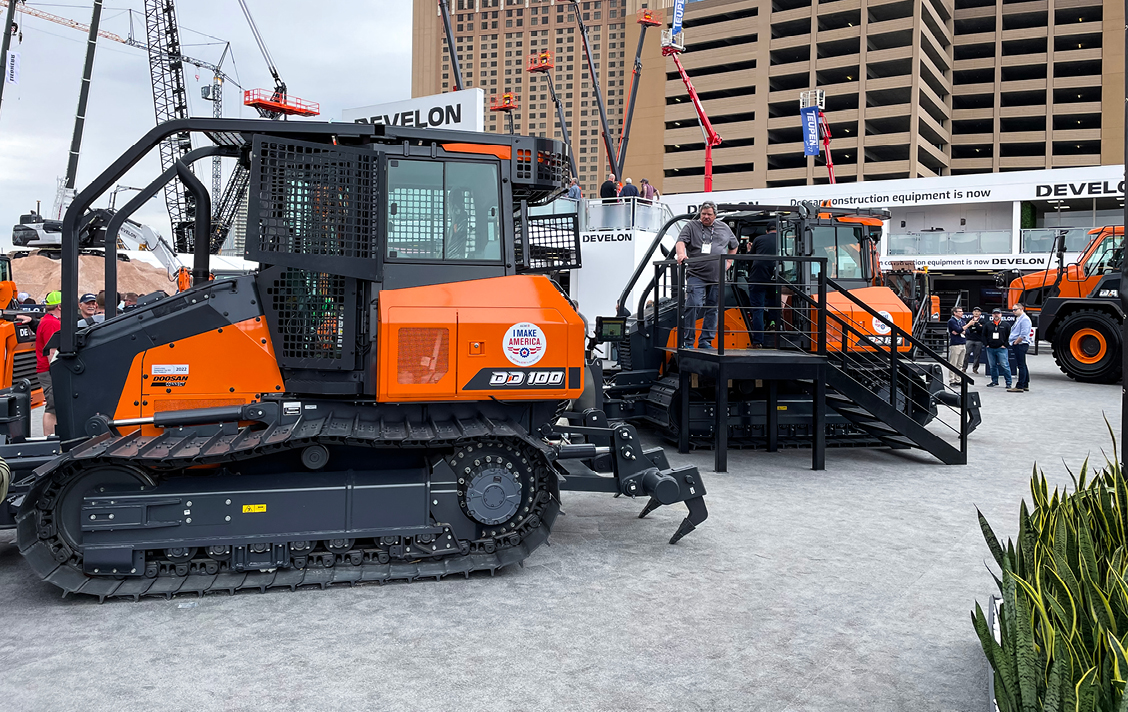 Photo of two DEVELON dozers on display at CONEXPO in the DEVELON booth.