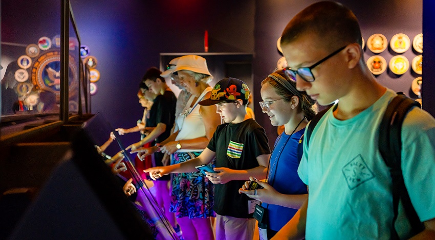 Kids and grandparents looking at an exhibit in the NSA Cryptologic Museum