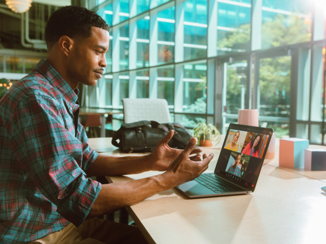 man at desk on glass wall