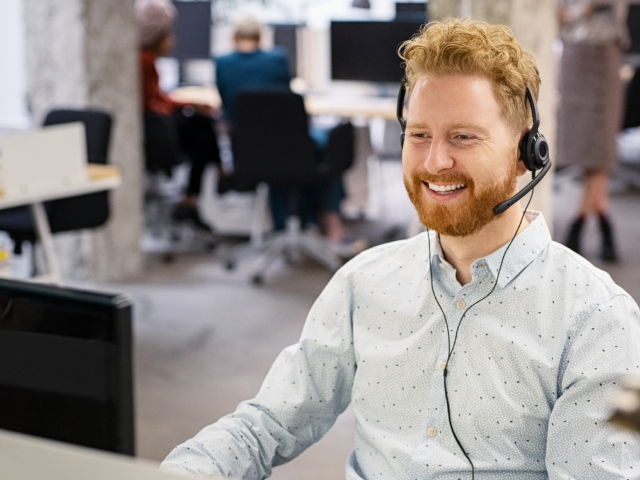 Man working at desk with headphones Man working at desk with headphones