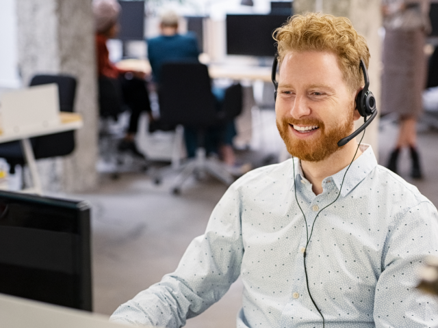 Man working at desk with headphones