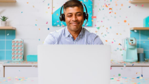 Man at computer with confetti
