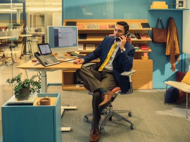 man using desk phone man using desk phone