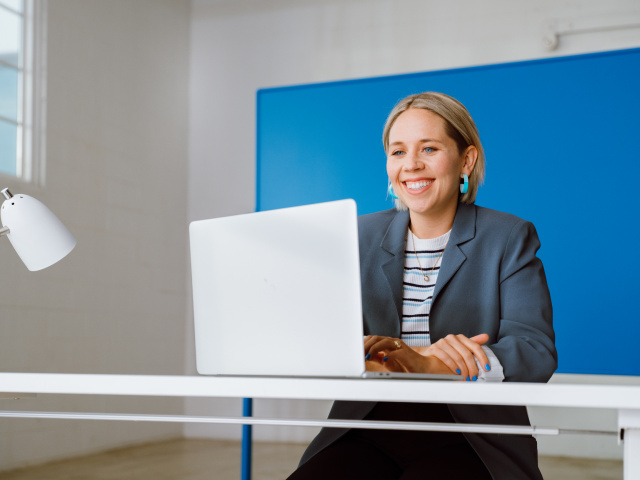Woman smiling at computer Woman smiling at computer