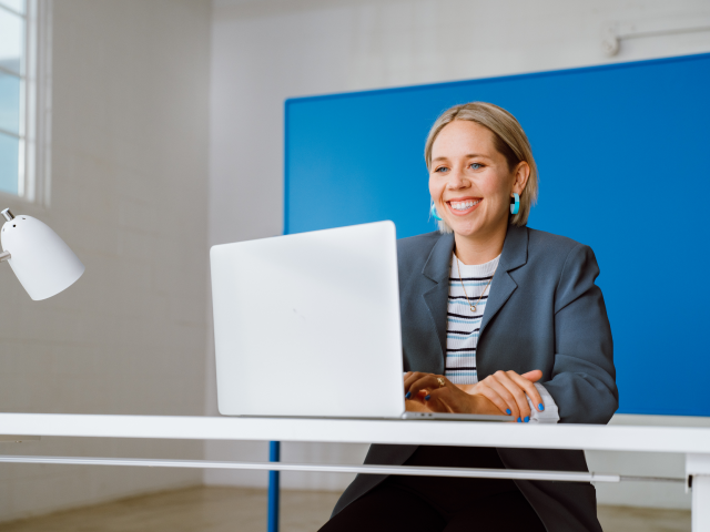 Woman smiling at computer